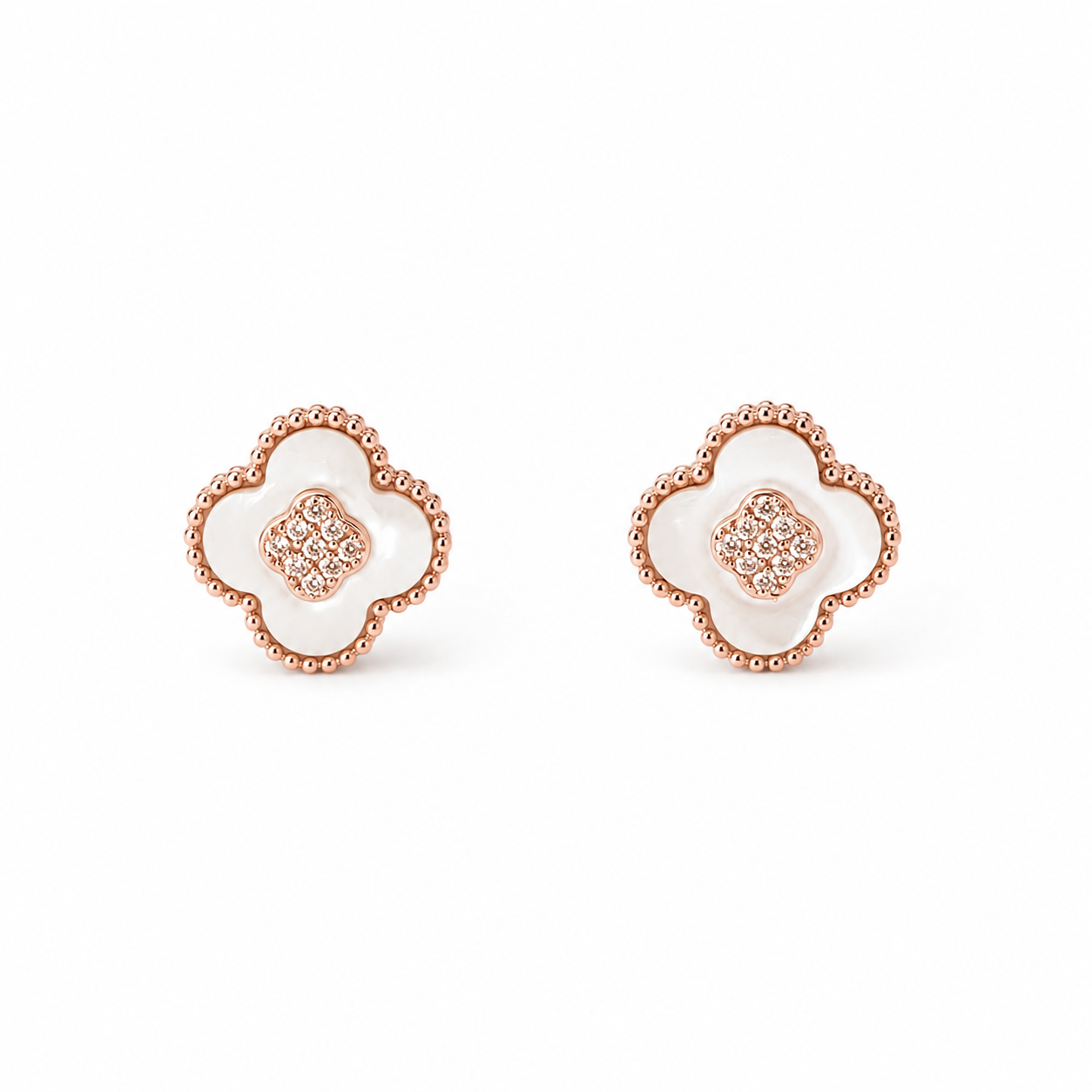 A pair of rose gold four-leaf clover stud earrings with white inlay and a pavé-set diamond center, shown on a plain white background.